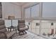 Enclosed porch with a pair of chairs and nice natural light from the surrounding windows at 200 The Esplanade N # C19, Venice, FL 34285
