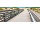 Inviting beach access via a wooden walkway, leading to the sandy shore and turquoise ocean at 200 The Esplanade N # C19, Venice, FL 34285
