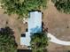 Overhead aerial shot reveals the roof and layout of the home and its location within a tree-filled property at 2008 55Th E Ave, Bradenton, FL 34203