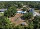 Aerial view showcases the home's position within a neighborhood, surrounded by trees and other residences nearby at 2008 55Th E Ave, Bradenton, FL 34203