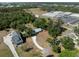 Aerial view of a house with gravel driveway and neighborhood in the background, surrounded by lush greenery at 2008 55Th E Ave, Bradenton, FL 34203