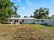 Expansive backyard view featuring a well-maintained lawn, patio area, and the home's back exterior at 2008 55Th E Ave, Bradenton, FL 34203