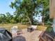 Relaxing backyard patio with a brick paver area, seating, grill and view of the spacious lawn at 2008 55Th E Ave, Bradenton, FL 34203