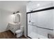 Bright bathroom featuring a dual sink vanity, bronze fixtures, shiplap accent wall and a glass enclosed shower at 2008 55Th E Ave, Bradenton, FL 34203