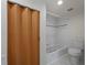 Compact bathroom featuring tile floors, a standard toilet, tub and wood door at 2008 55Th E Ave, Bradenton, FL 34203