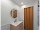 Charming bathroom features a modern vanity, stylish mirror and wood door at 2008 55Th E Ave, Bradenton, FL 34203
