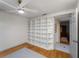 Bedroom featuring a large built-in shelf, hardwood floors, modern ceiling fan, and natural light at 2008 55Th E Ave, Bradenton, FL 34203