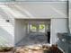 Open carport with concrete floor, side door, and view of the fenced yard behind the home at 2008 55Th E Ave, Bradenton, FL 34203