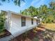Charming single-story home featuring updated siding, dark trim windows, and lush landscaping at 2008 55Th E Ave, Bradenton, FL 34203