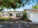 Charming single-story home featuring updated siding, dark trim windows, an attached carport and lush landscaping at 2008 55Th E Ave, Bradenton, FL 34203