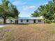 Charming single-story home featuring updated siding, dark trim windows, and lush landscaping at 2008 55Th E Ave, Bradenton, FL 34203