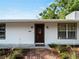 Charming home featuring updated siding, dark trim windows, a brick walkway and lush landscaping at 2008 55Th E Ave, Bradenton, FL 34203