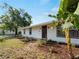 Charming single-story home featuring updated siding, dark trim windows, and lush landscaping at 2008 55Th E Ave, Bradenton, FL 34203