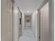 Well-lit hallway with consistent flooring and neutral walls connecting different rooms in the house at 2008 55Th E Ave, Bradenton, FL 34203