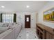 Inviting living room with stylish front door, sleek tile floor, and comfortable seating arrangement at 2008 55Th E Ave, Bradenton, FL 34203