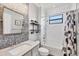 Stylishly updated bathroom featuring a vanity with elegant fixtures and a shower with decorative tile at 20235 Granlago Dr, Venice, FL 34293
