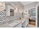 This bathroom offers double vanities, modern mirrors, and access to the main bedroom at 20235 Granlago Dr, Venice, FL 34293