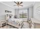 Bright bedroom with large window, ceiling fan, and neutral decor providing a relaxing atmosphere at 20235 Granlago Dr, Venice, FL 34293