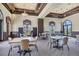 Spacious game room with multiple tables and chairs for entertainment at 20235 Granlago Dr, Venice, FL 34293