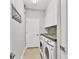 Efficient laundry room with washer, dryer, countertop space, and storage cabinets at 20235 Granlago Dr, Venice, FL 34293