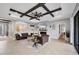 Cozy living room with stylish furnishings, modern fireplace, and decorative ceiling beams at 20235 Granlago Dr, Venice, FL 34293