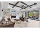Inviting living room boasting comfortable seating, a modern fireplace, and serene outdoor views at 20235 Granlago Dr, Venice, FL 34293