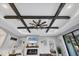 Stylish living room with decorative ceiling beams, modern fireplace, and inviting ambiance at 20235 Granlago Dr, Venice, FL 34293