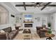 Charming living room featuring comfortable furnishings, a decorative fireplace, and open layout at 20235 Granlago Dr, Venice, FL 34293