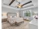 Spacious main bedroom with tray ceiling, decorative fan, and natural light at 20235 Granlago Dr, Venice, FL 34293