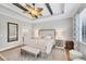 Stylish main bedroom boasts a tray ceiling, decorative fan, and access to ensuite at 20235 Granlago Dr, Venice, FL 34293