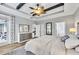 Bright main bedroom features wood flooring, tray ceiling, and access to the patio at 20235 Granlago Dr, Venice, FL 34293