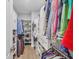 Spacious walk-in closet with custom shelving and ample storage for clothes, shoes, and accessories at 20235 Granlago Dr, Venice, FL 34293