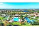 Aerial view of community amenities featuring pool, tennis, bocce ball, and clubhouse at 213 Malina Ct, Nokomis, FL 34275