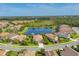 A picturesque aerial view of a residential area highlighting a central pond and manicured landscaping at 213 Malina Ct, Nokomis, FL 34275