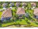Aerial view of the neighborhood showcasing beautiful landscaping and serene lake at 213 Malina Ct, Nokomis, FL 34275