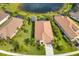Aerial shot showcasing lush backyard landscaping, screened-in patios, and a tranquil pond at 213 Malina Ct, Nokomis, FL 34275