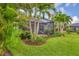 A screened patio and lush tropical landscaping make for a relaxing outdoor space at 213 Malina Ct, Nokomis, FL 34275