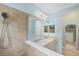 Modern bathroom featuring a double sink vanity and a tiled walk-in shower at 213 Malina Ct, Nokomis, FL 34275