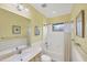 Bright bathroom featuring a shower-tub combo, single sink vanity, and yellow walls at 213 Malina Ct, Nokomis, FL 34275