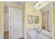 Bright bathroom featuring a single sink vanity and white cabinets and trim at 213 Malina Ct, Nokomis, FL 34275