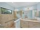 Bathroom features a glass shower, double vanity, and neutral tile at 213 Malina Ct, Nokomis, FL 34275