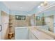 Neutral bathroom with beige tile, glass shower and double vanity at 213 Malina Ct, Nokomis, FL 34275