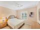 Cozy bedroom with a queen-sized bed, ceiling fan, and plantation shutters at 213 Malina Ct, Nokomis, FL 34275