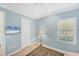 Stylish bedroom featuring a TV, plantation shutters, and blue walls at 213 Malina Ct, Nokomis, FL 34275