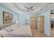 Bedroom boasts blue walls, trey ceilings, and shuttered windows at 213 Malina Ct, Nokomis, FL 34275