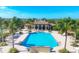 An aerial view features a luxurious community pool with a building nearby at 213 Malina Ct, Nokomis, FL 34275