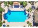 Aerial view of a community pool and sundeck with tropical landscaping at 213 Malina Ct, Nokomis, FL 34275