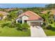 Aerial view highlighting a tile-roofed home complemented by palm trees and a picturesque pond setting at 213 Malina Ct, Nokomis, FL 34275