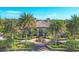 Lush tropical landscaping surrounds this luxurious home with tile roof and fountain at 213 Malina Ct, Nokomis, FL 34275
