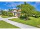 Well-maintained home with a tile roof, lush landscaping, and a welcoming driveway at 213 Malina Ct, Nokomis, FL 34275